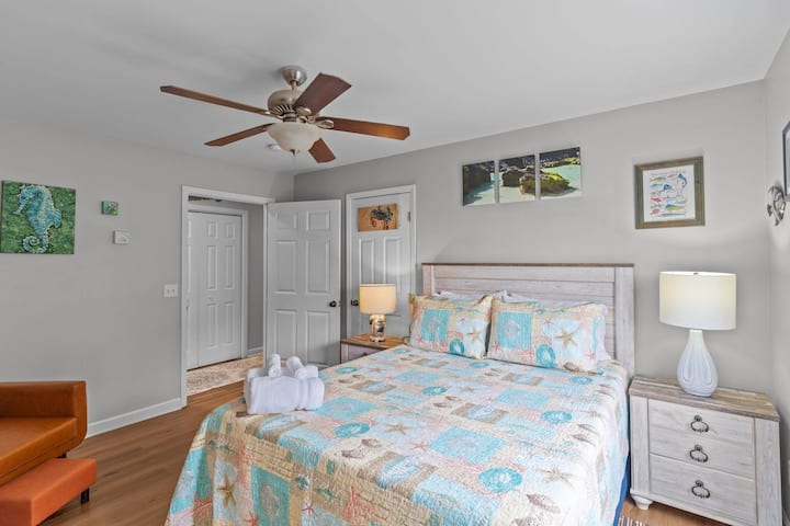 Relax in this bright bedroom with a queen bed and private bathroom.