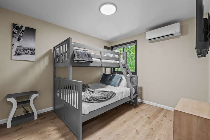 Cozy nights and happy mornings in this twin-over-twin bunk  Perfect setup for kids and friends, complete with a closet, TV, and split system for comfort! #VacationVibes #BunkroomInspo #FamilyFun