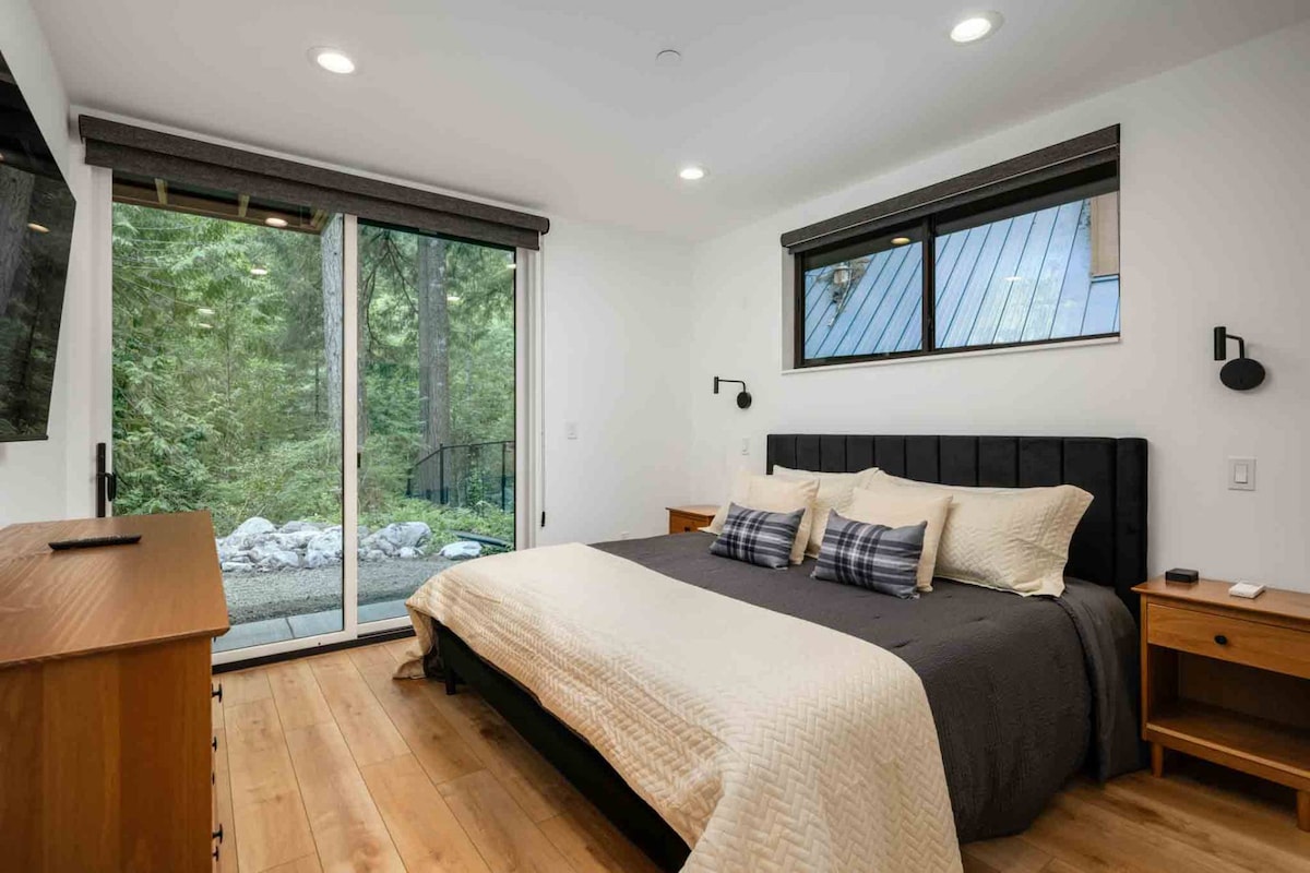 This room has a comfy bed, smart tv, and gorgeous forest view.