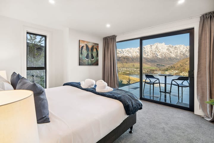 Bedroom 1, First Floor. 
Wake up to lake and mountain views from your private balcony.