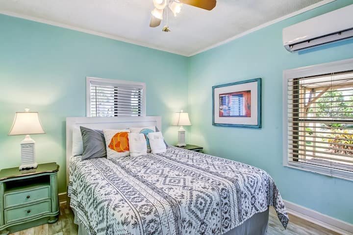 Dormitorio con ropa de cama cómoda y relajante pared decorativa turquesa.