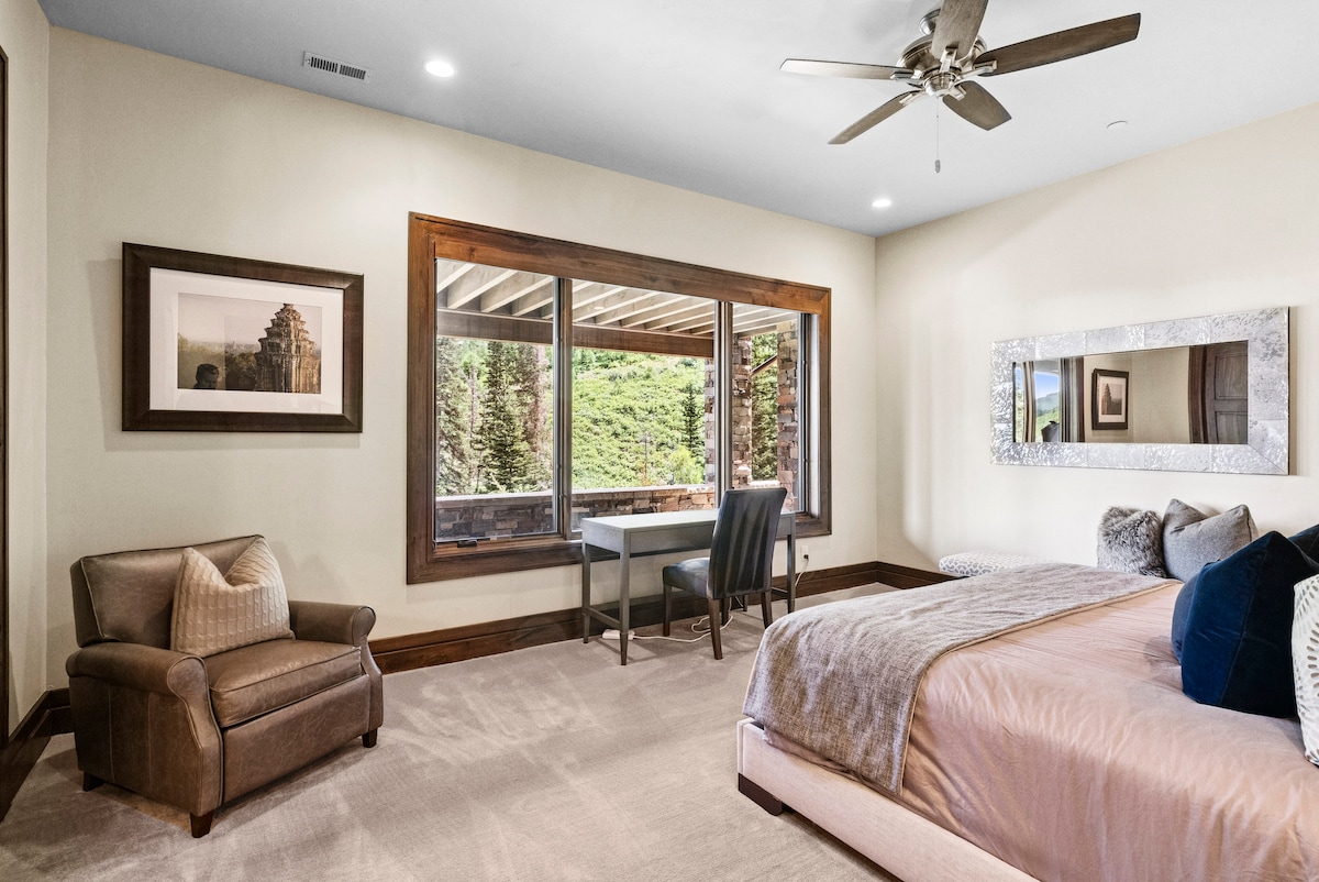 view of a guest suite with a large window and plush bedding