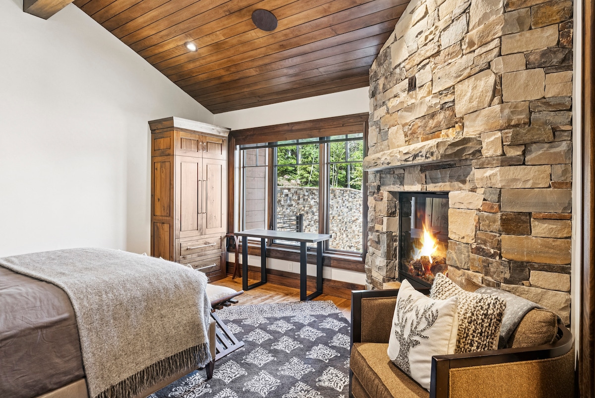 guest suite with stone fireplace and cozy seating