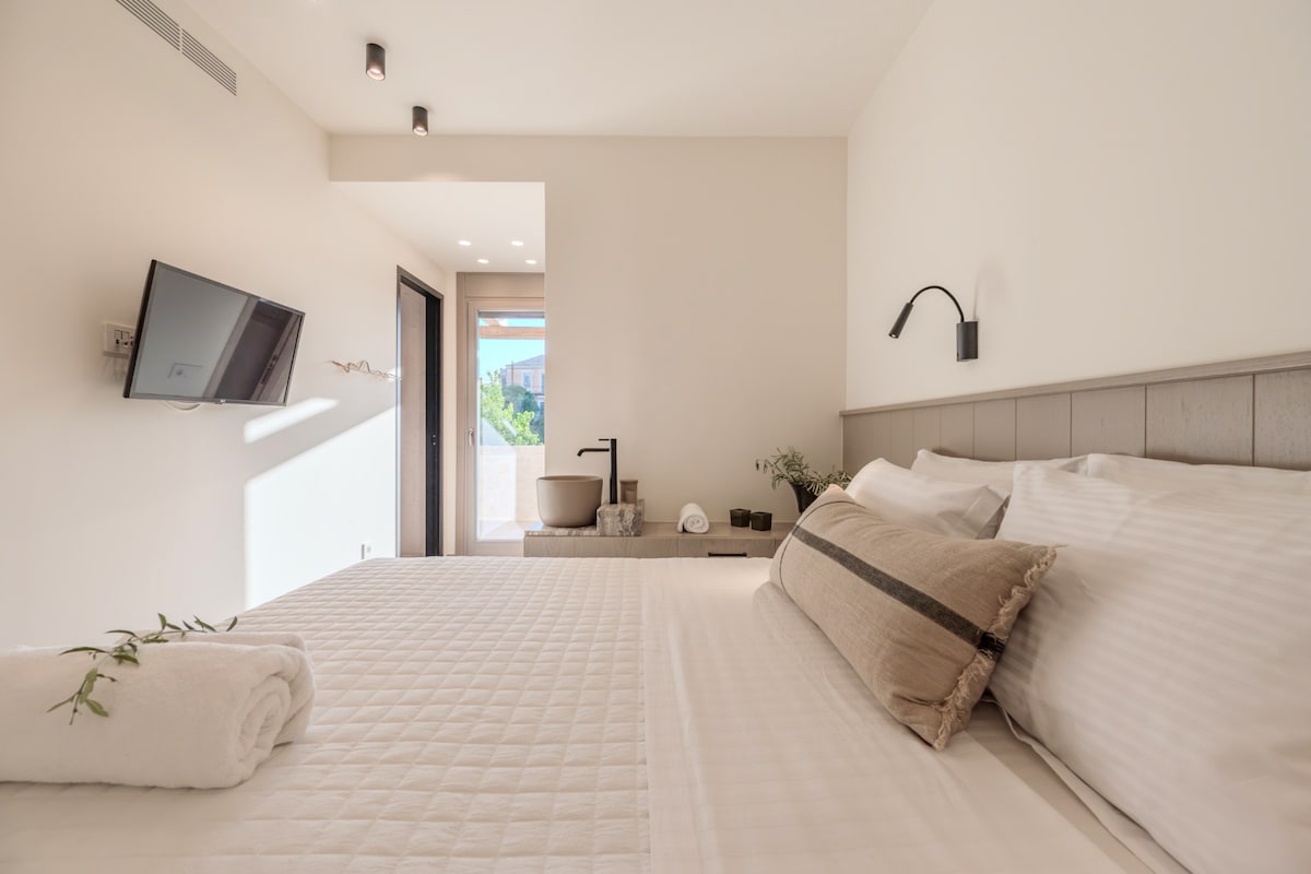 Het queensize bed van de tweede slaapkamer en de patio-deur naar het zijterras.