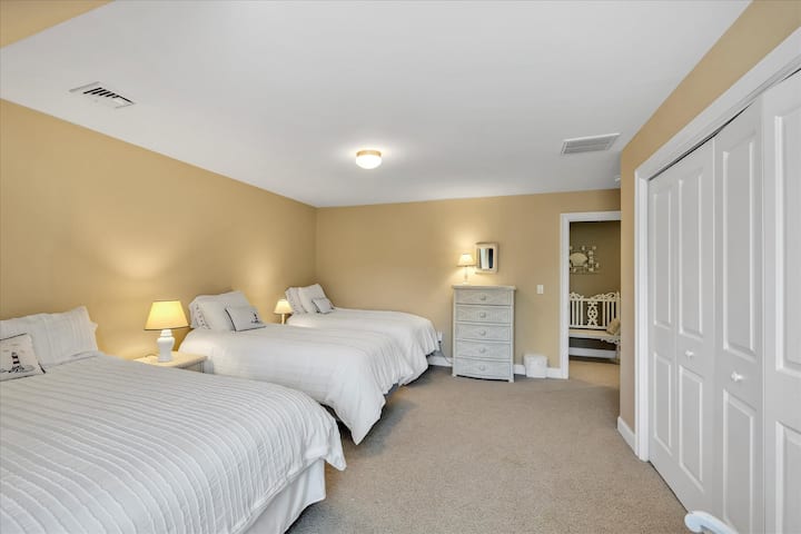 image 61 of 77, This cozy upstairs bedroom features three plush beds, ideal for families or friends traveling together.