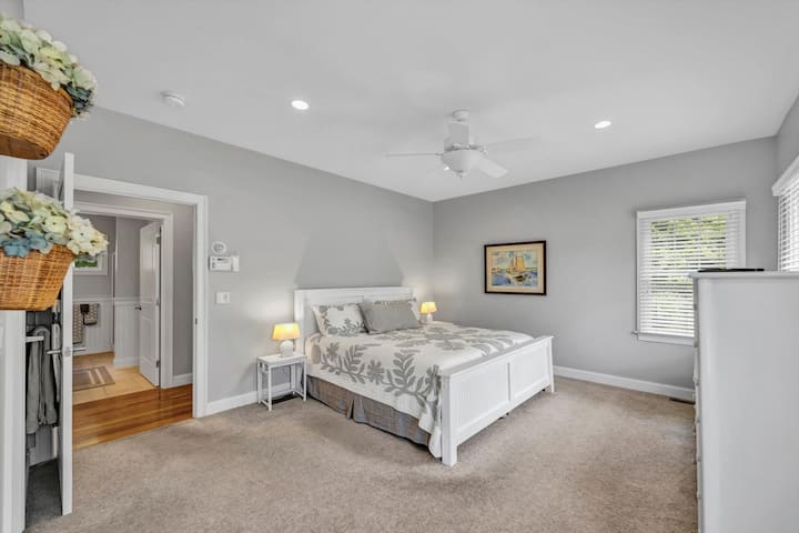 image 13 of 77, This large primary bedroom includes a walk-in closet and en suite access, designed for restful nights and easy mornings.