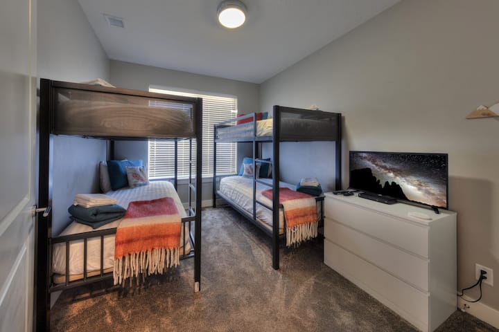 A flexible bunk room designed for comfort and practicality—ideal for groups who want efficient sleeping space, room to relax, and an easy place to recharge after full days exploring Moab.