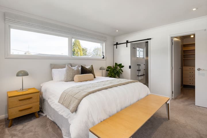 Suite principale luxueuse avec un très grand lit, un dressing et une salle de bain privée. Votre retraite personnelle pour un confort ultime.