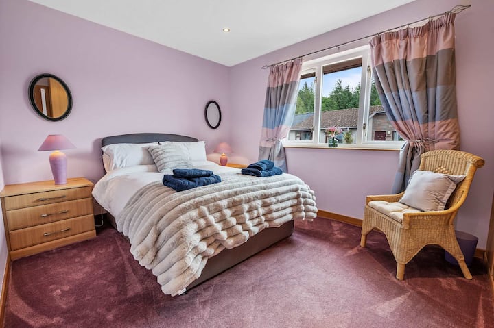 Elegant king bedroom with soft lighting and plush carpets.