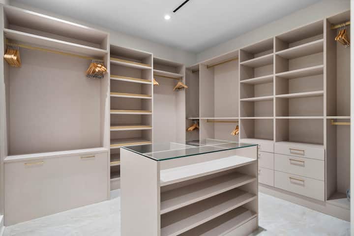 Primary bedroom walk in closet