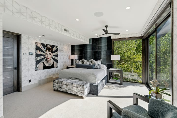 second primary suite with custom wallpaper and art