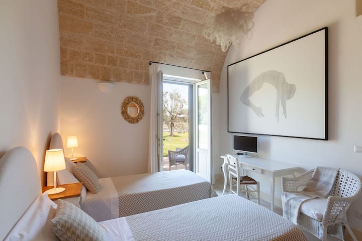 غرفة النوم المزدوجة المغطاة بسقف برميلي قبالة غرفة المعيشة الرئيسية. (غرفة النوم 4)