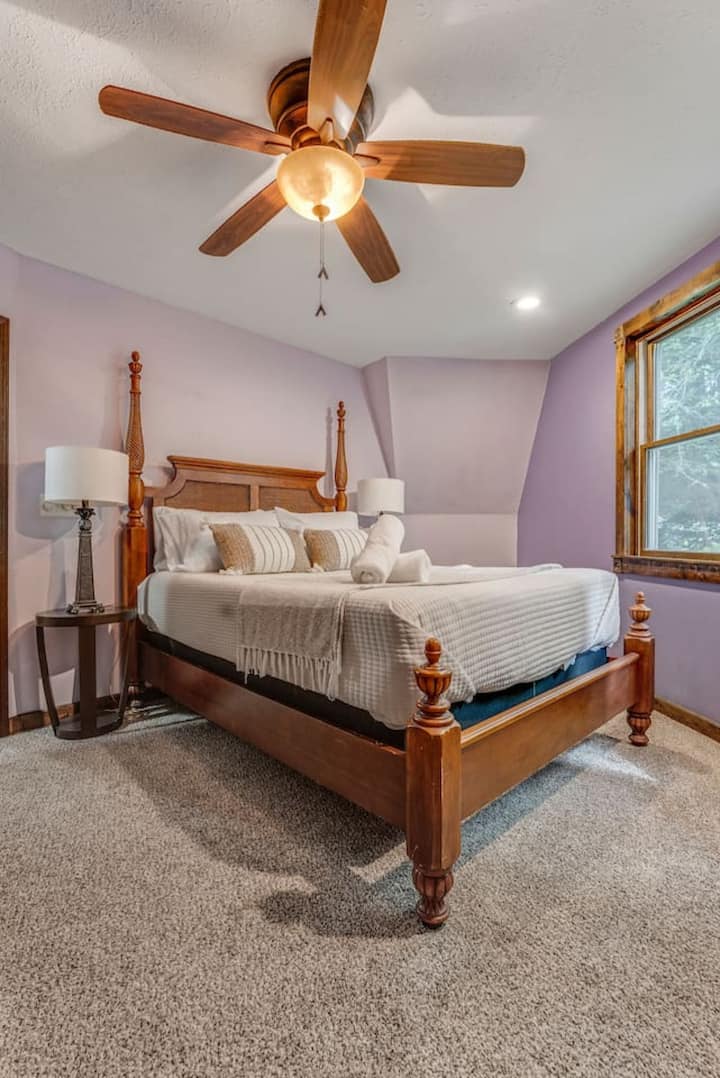 Bedroom 4 - Main Level
Elegant antique queen bed with peaceful wooded views. Includes an electric fireplace and streaming TV for a cozy and relaxing atmosphere.