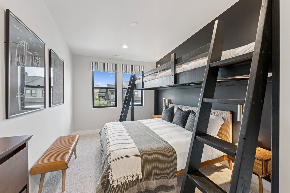 Bunk suite I with built-in black bunk beds, windows, and seating bench.