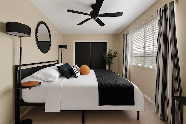 Bedroom 5: A spacious retreat with a plush king bed, styled in bold black and orange accents, offering both comfort and modern elegance.