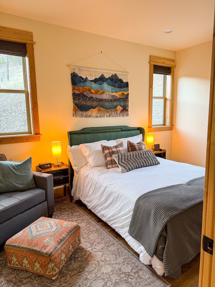 Bedroom 2: A cozy retreat with a queen bed and an extra pull-out chair. 