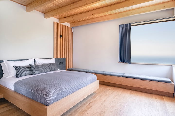 The double bedroom on the first floor of the west wing with its sea-view corner window (bedroom 5). 