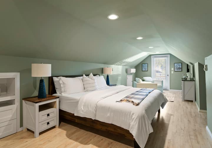Bedroom 3, located on the upper level, features a king bed and a TV.
