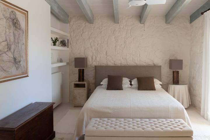 The main bedroom, a double, with its white-washed walls and wood beamed ceilings. (Bedroom 1)