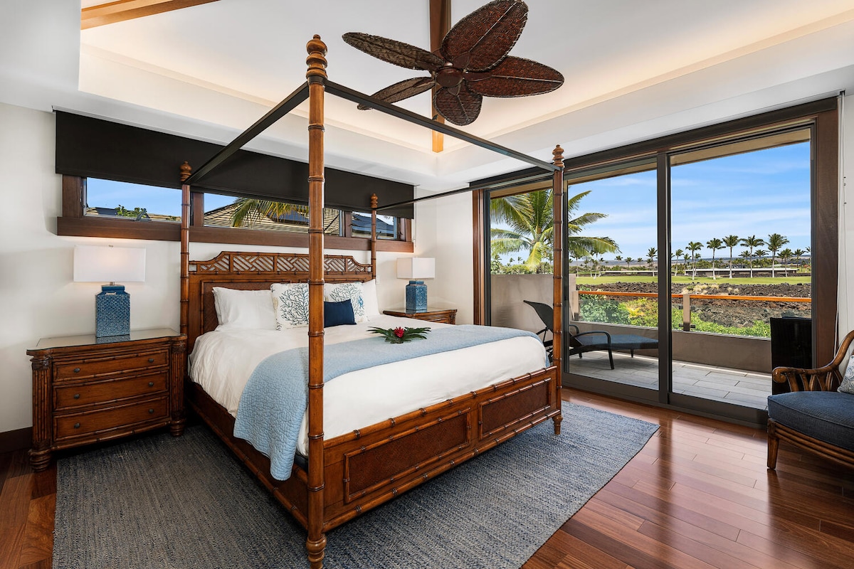 Primary suite with king bed, TV, custom canopy frame, and private lanai access at Laule'a #13.