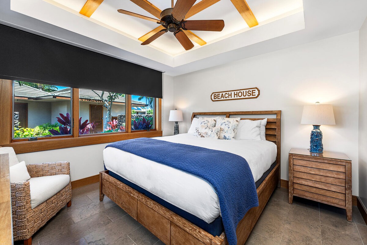 Guest suite with king bed, TV, tropical garden views, and ensuite bath at Laule'a #14.