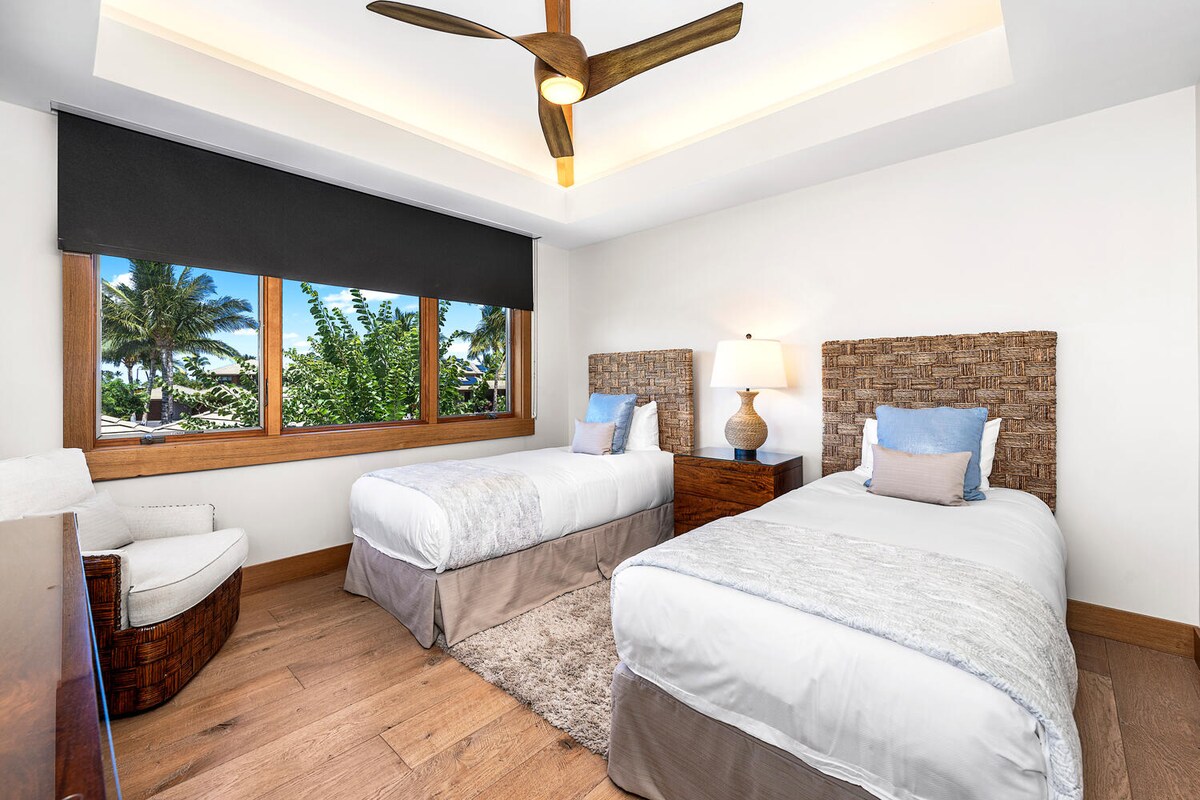 Twin bedroom ideal for kids or friends, with lush garden views and TV at Laule'a #14.