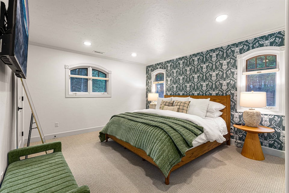 King bedroom with soft bedding and quiet windows