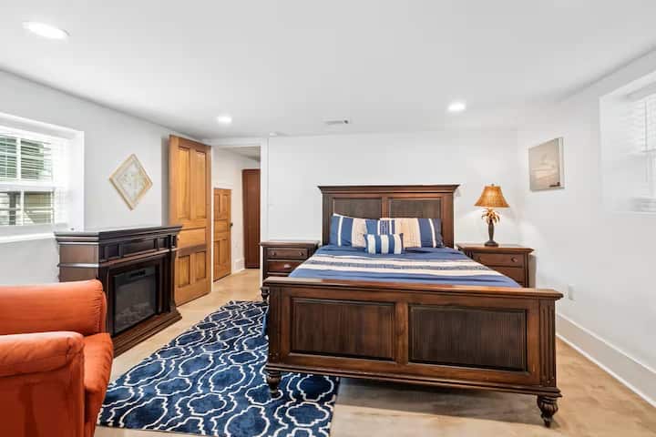 Amplio dormitorio con una cama tamaño queen, lujosa ropa de cama y muebles de madera clásicos para una noche de sueño cómoda.