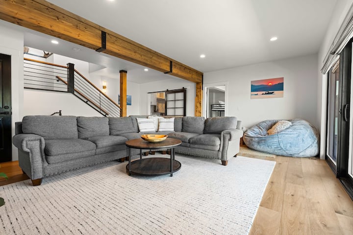 Modern design ontmoet bergwarmte. Houten balken, zacht textiel en zonovergoten tinten creëren een naadloze stroom van aan het meer naar luxe.