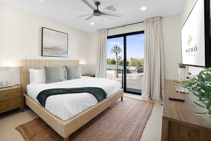A bright and inviting bedroom designed for a restful stay, with easy access to a shared bathroom.