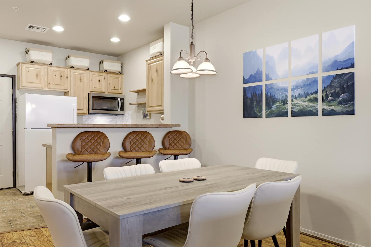 Bright kitchen-dining with breakfast bar, seats 6, stylish mountain art