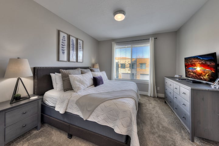 A comfortable King bedroom with plush bedding and a peaceful feel—designed for deep rest after active days in Moab