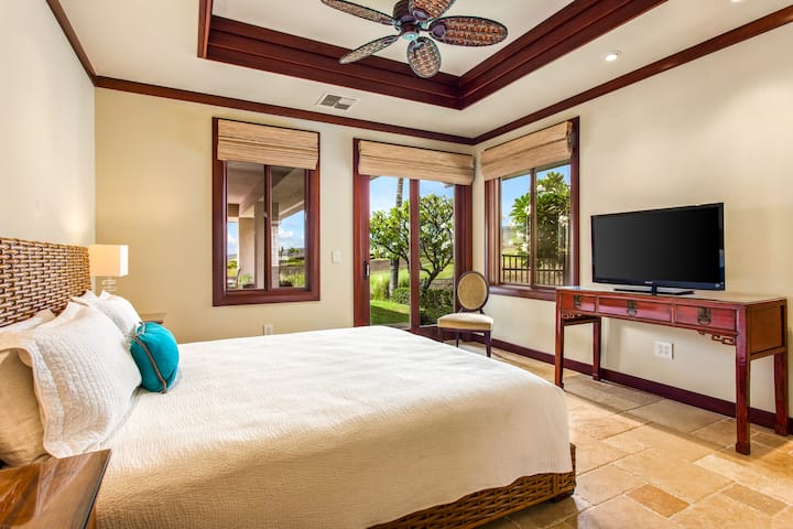 Enjoy garden and pool views right from bed in this bright, restful guest suite.