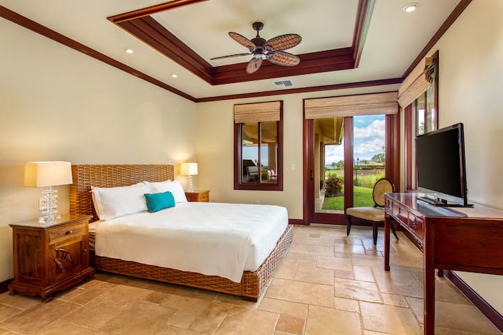 Bedroom 3 King Suite featuring lanai access, tropical views, and warm island décor.