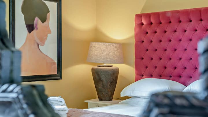 Pops of bright colour and artwork fill ground floor bedroom five with personality.