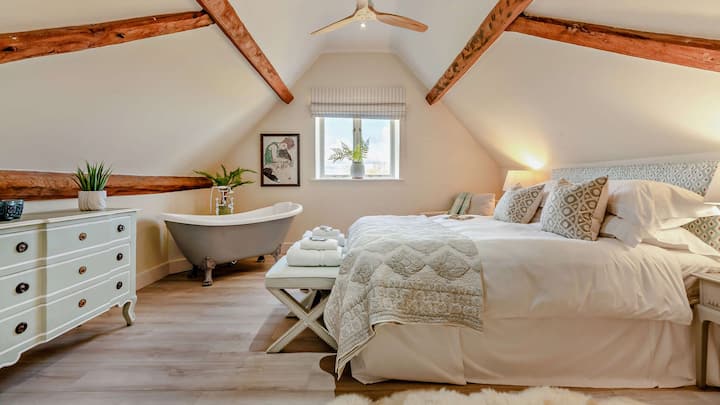 Relax in the beautiful master bedroom which has a king-size bed.