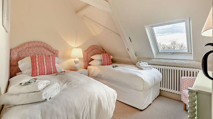 Mirroring bedroom three, bedroom four also has two single beds.