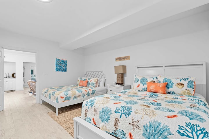 Roomy and coastal. Two queen beds ready for everyone to sleep comfortably after a day on the water.