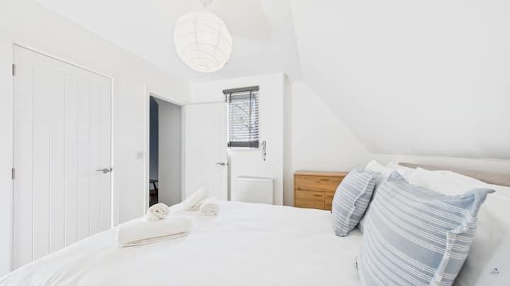 Druhý pohľad ukazujúci dostatok priestoru v šatníku a prirodzené svetlo z charakteristických okien.