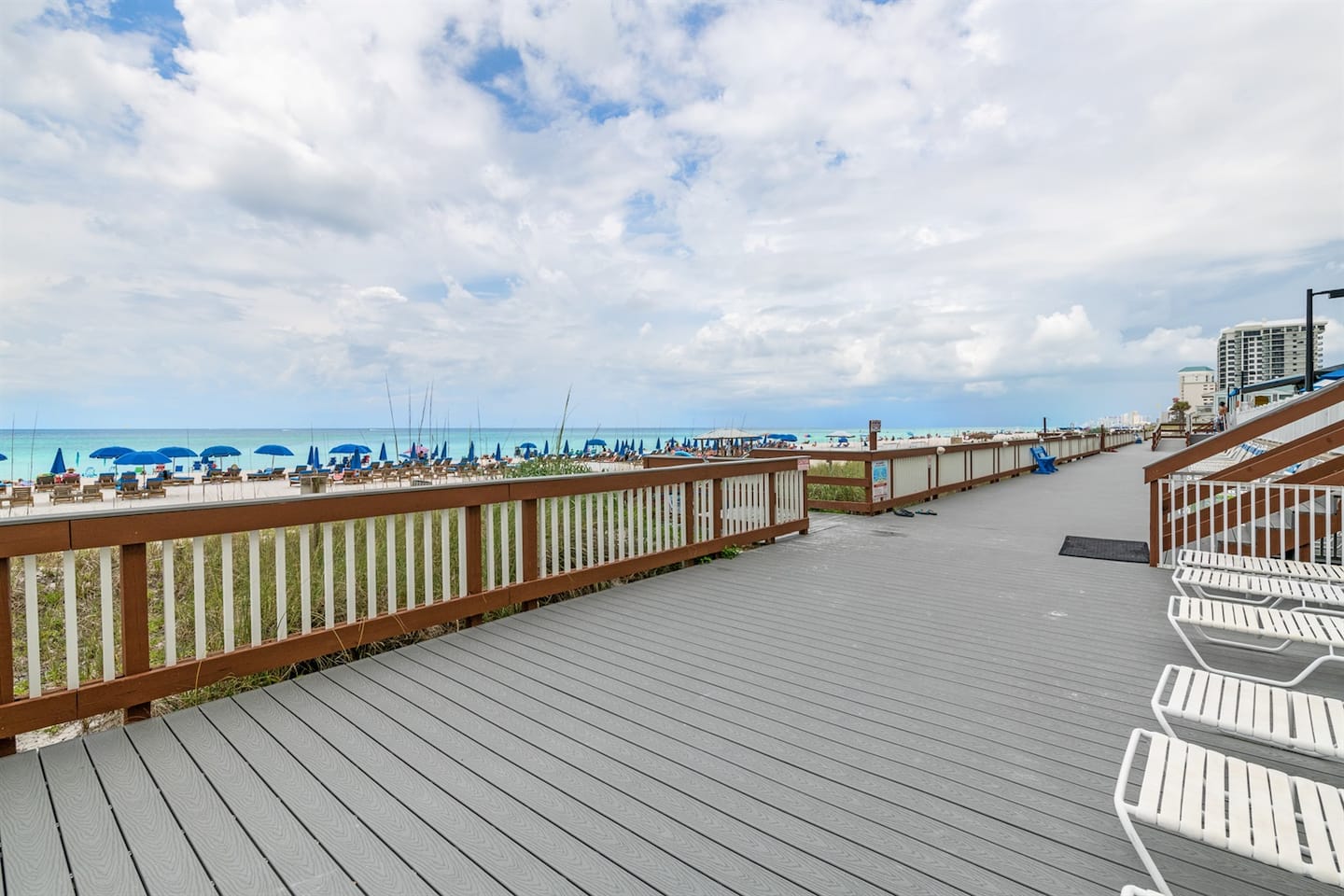 The building's private beach walkway leading down to the sand
