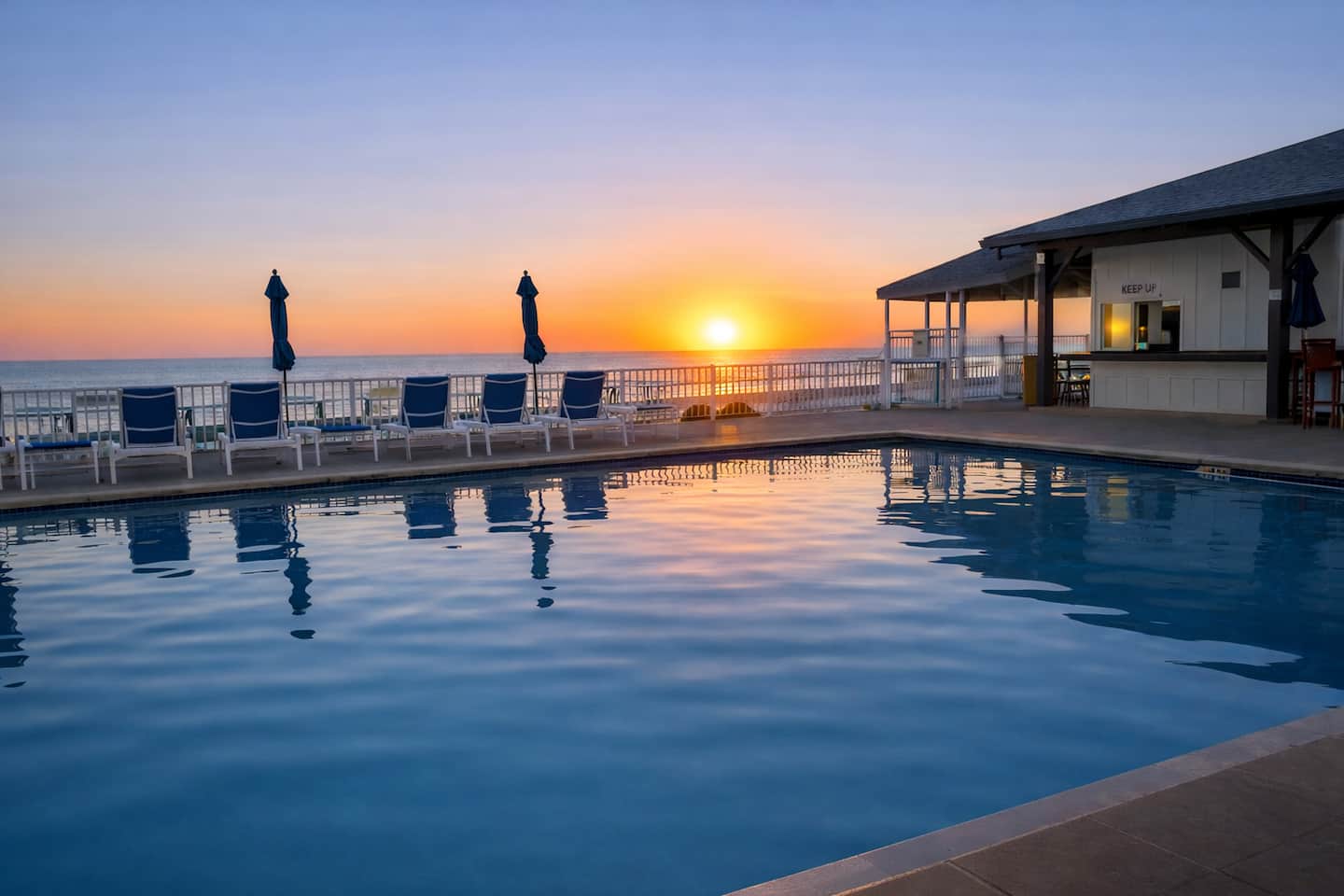 One of the three resort-style community pools at Regency Towers, at sunset