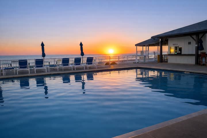One of the three resort-style community pools at Regency Towers, at sunset