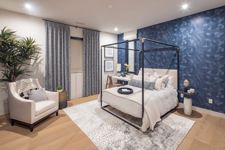 A sophisticated guest suite featuring a four-poster bed and rich finishes for a touch of luxury.