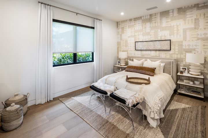 A cozy guest room with soft bedding and natural light, ideal for restful nights after days by the ocean.