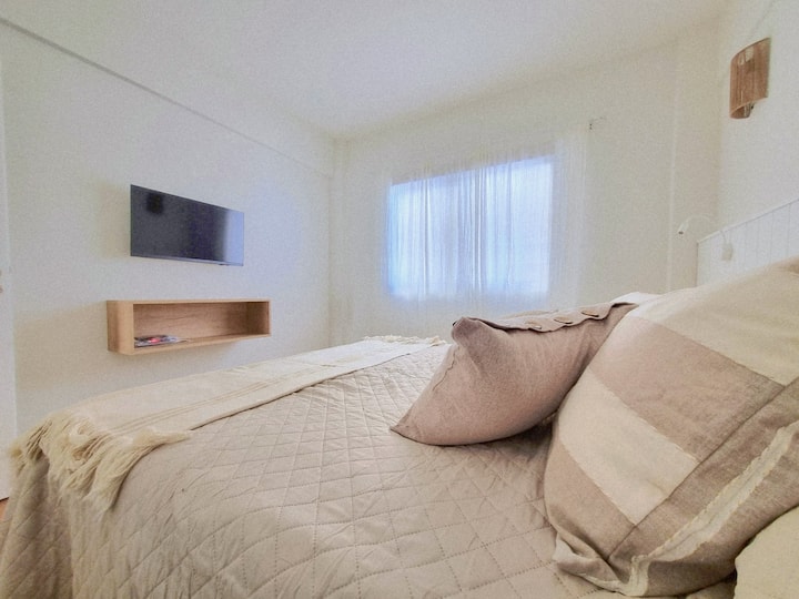 Dormitorio luminoso y acogedor con cama matrimonial, ropa de cama suave y TV Smart. Espacio ideal para descansar y disfrutar de la calma del lugar.