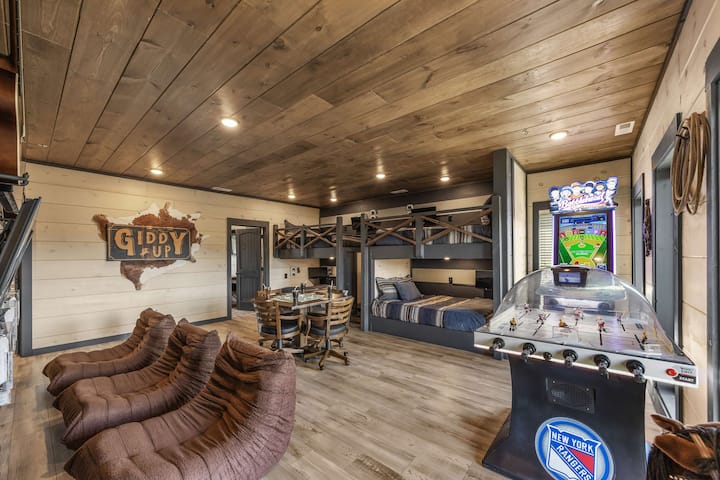 Open game lounge w/ shuffleboard, arcade games & space to gather together