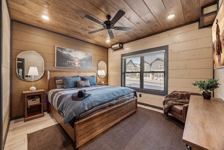 Rustic king suite w/ warm wood finishes & large windows for a peaceful retreat