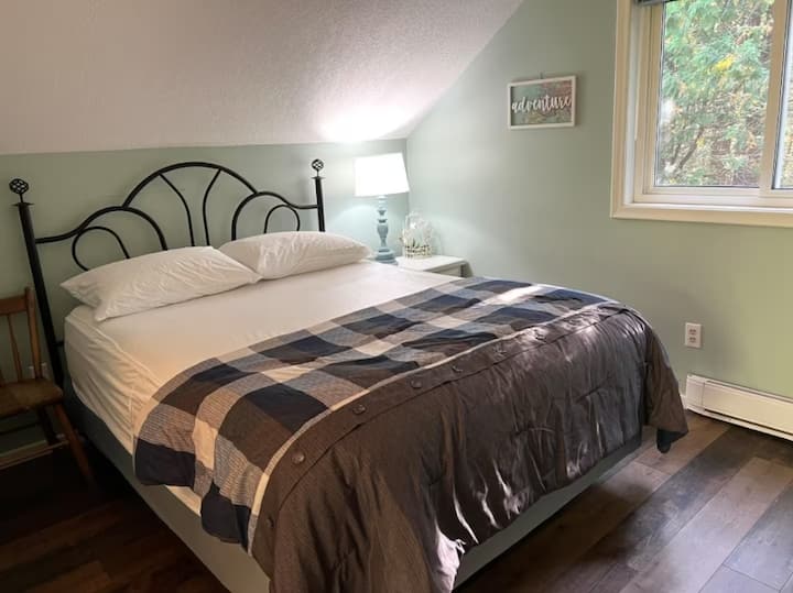 Relax in comfort after a day exploring the Bruce Peninsula. Fresh linens, a cozy quilt, and tranquil views make this space perfect for rest and rejuvenation.