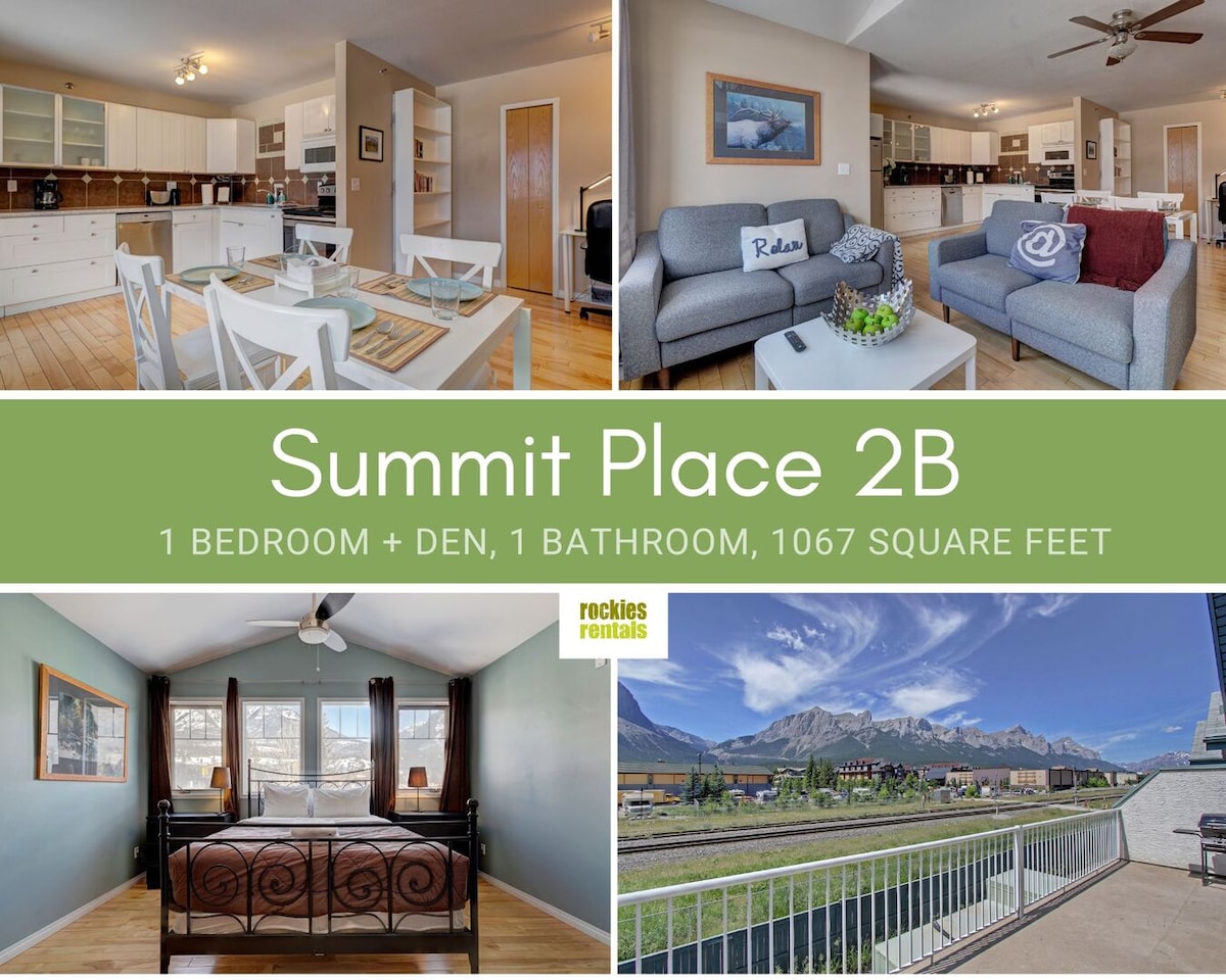 The open-plan kitchen and dining area features a modern dining table with seating for four. A cozy living space showcases a comfortable sofa and a soothing color palette, complemented by natural light from large windows that offer views of the mountains.
