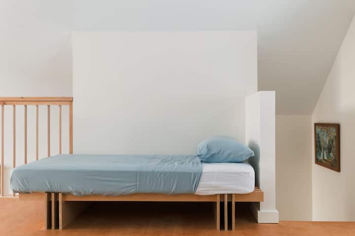 The loft has a single bed, a desk space, a reading corner + the best view of Lac George — all open concept with the main floor so you can enjoy the sounds of the fire.